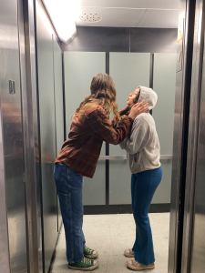Malea Malendrez and Lillian Afridi about to share an intimate moment in the elevator.