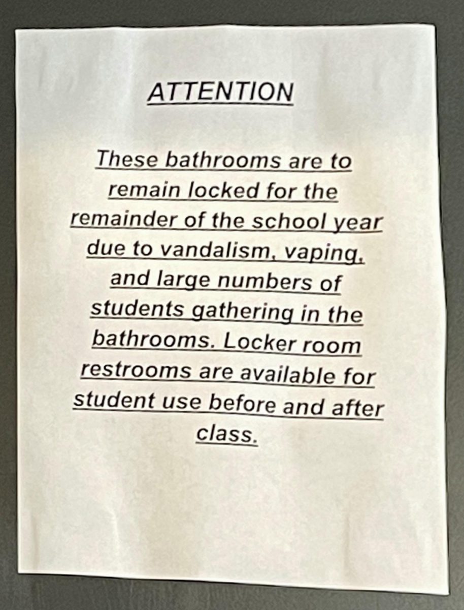 Sign posted on gym bathroom door.
