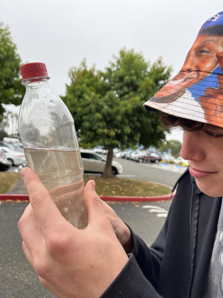 Noa Mitchel examining school water.