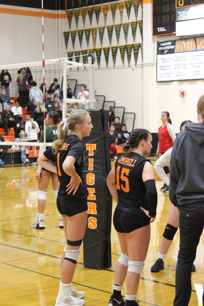 Captains from left to right: senior Quincy Collins (1) and senior Bella Campbell (15) starting game coin toss to decide who gets serve