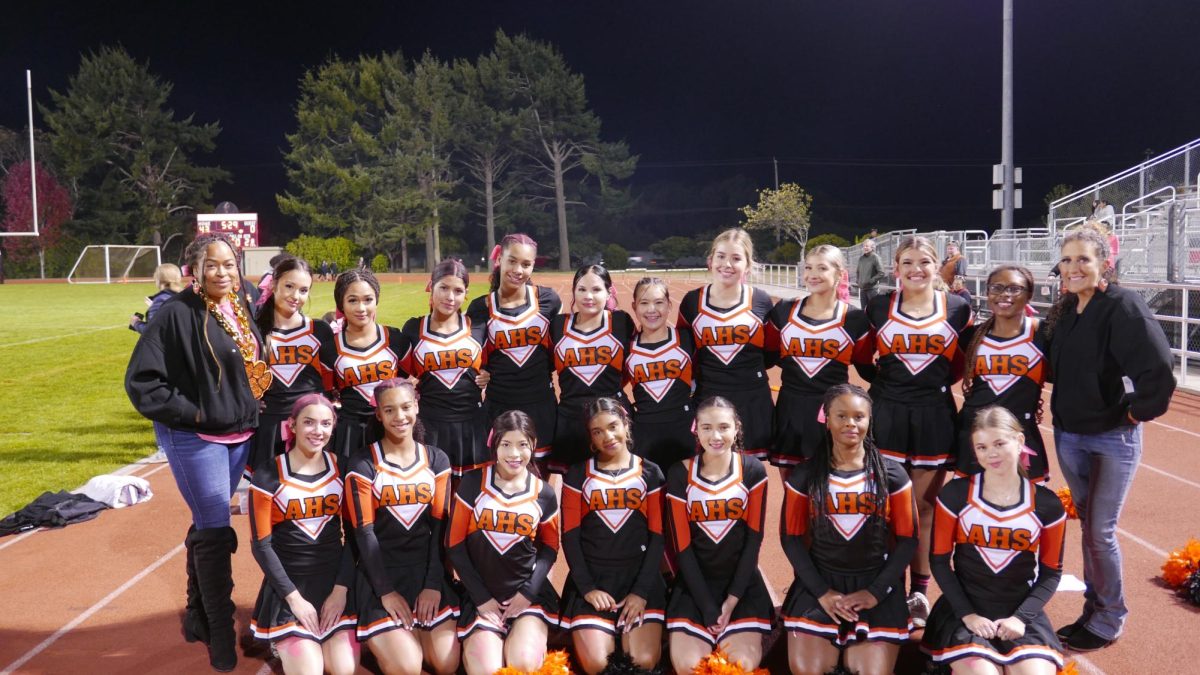 The cheer team at half time with their coach (left)