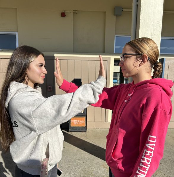 Senior Mayleah Jackson and junior Mia Cueto stopping from kissing. 