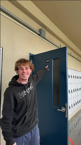 Senior Jack Martin Miller in front of room 204