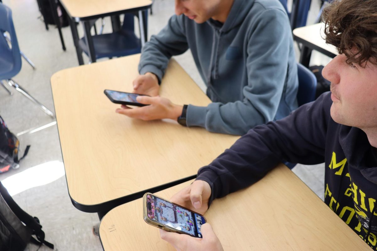 Ocean Walker and Thomas FitzMaurice playing Clash Royale during class