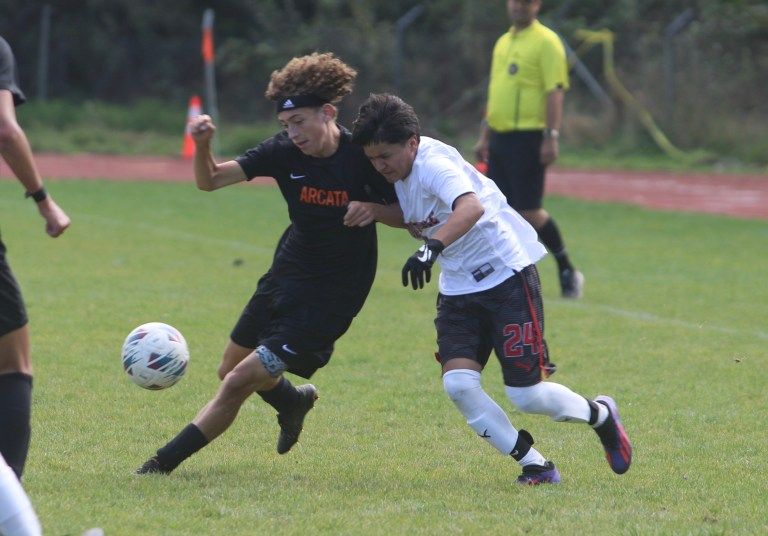 Julian Gillespie taking the ball from Pedro Ramirez