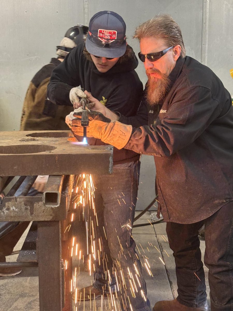 Braylan Downing learning how to use the propane cutting torch