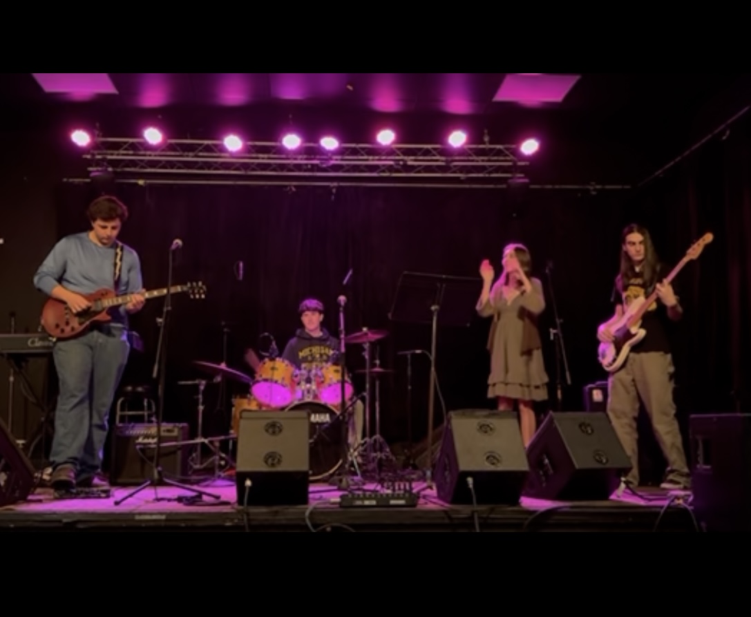 Students playing music at an AAI showcase. 