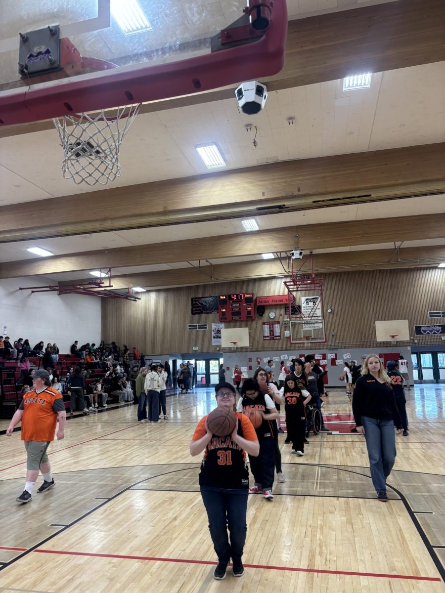 Special Olympics warming up for their game agasint Mack