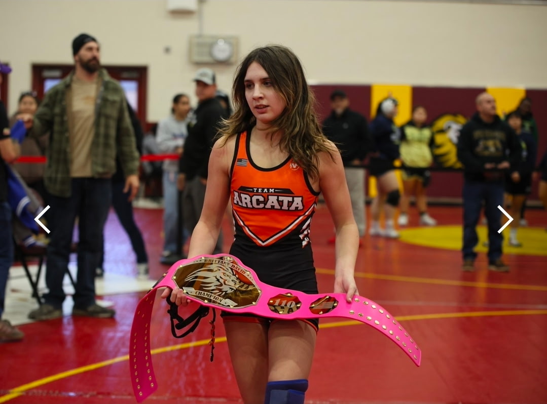 Taylor Bell holding her first place belt at the Brittany David Championship.