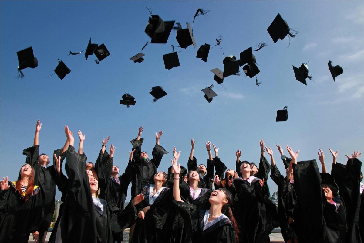 Students throwing caps in the air. 