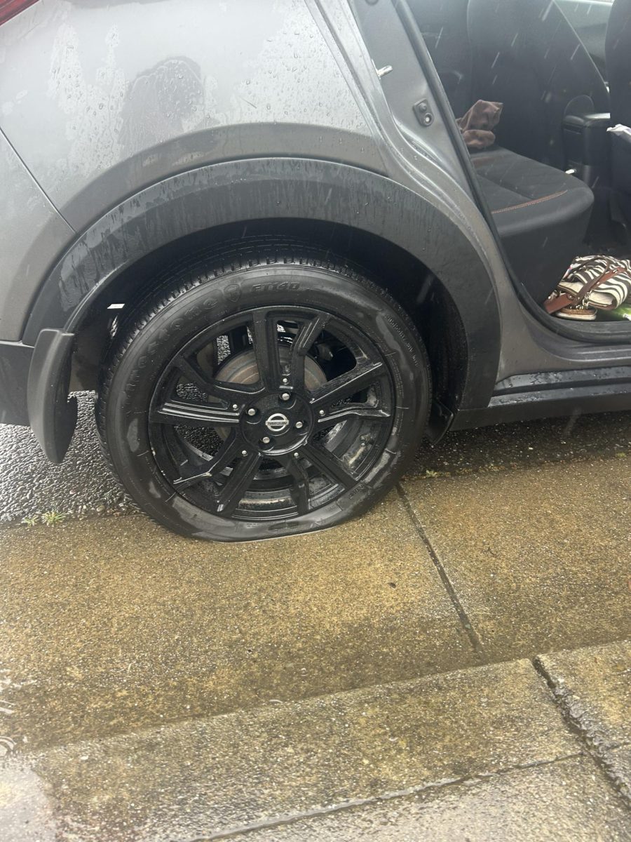 Photo of flat tire on students car.