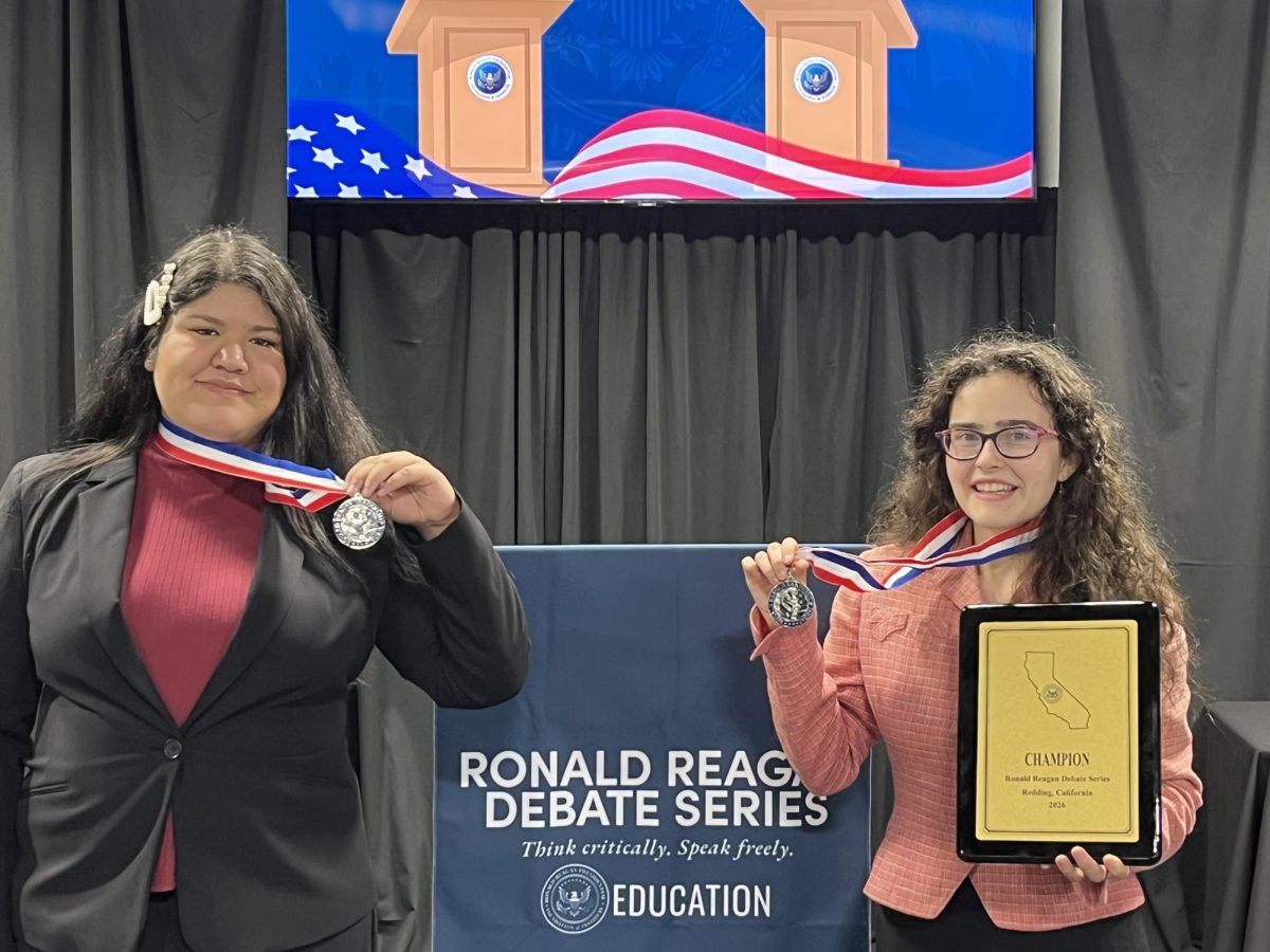 Herrera (left) and Caruso (right) display their prizes at the end of the debate series as second and first place, respectively